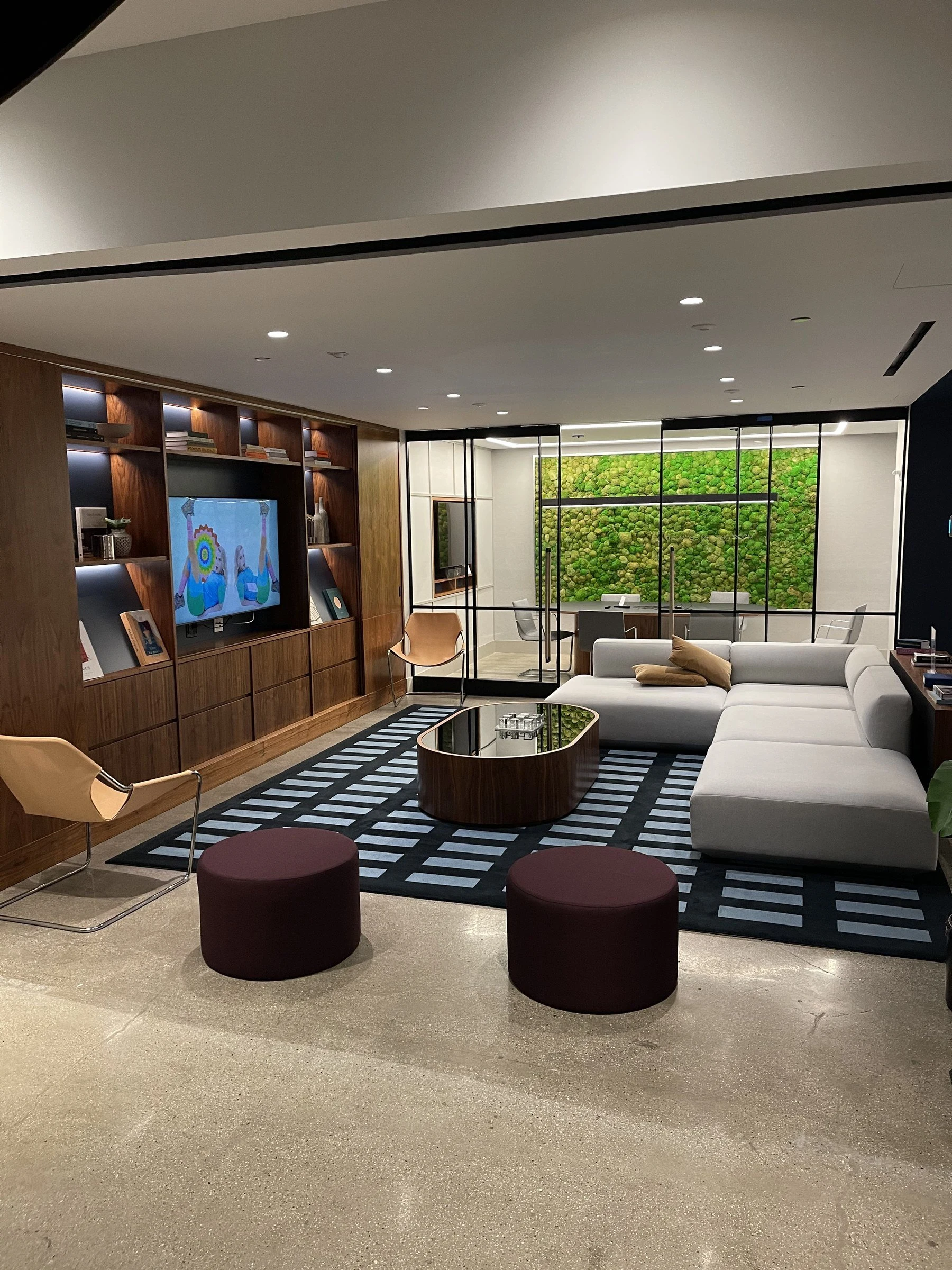 An amenity lounge cared for by Luxor, with polished stone, wood finishes, and upholstered seating